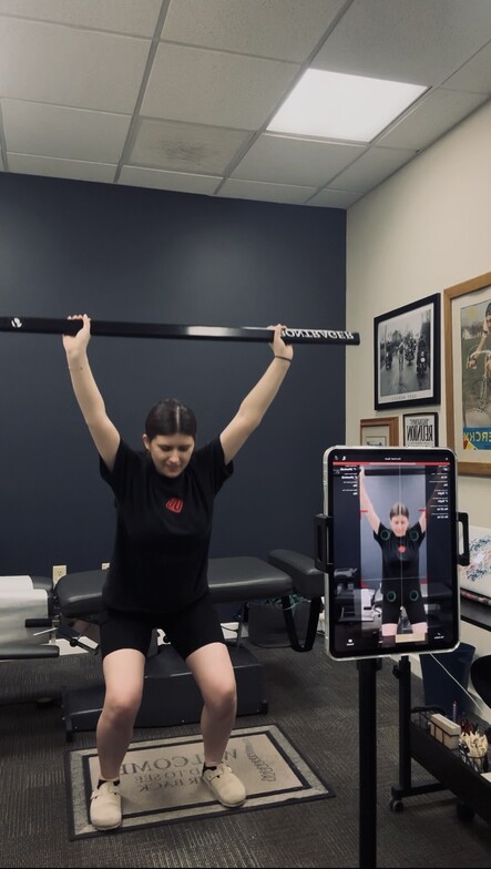 Patient performing an overhead squat during a Kinetisense AI motion capture assessment at Anchor Chiropractic in Somerville, NJ