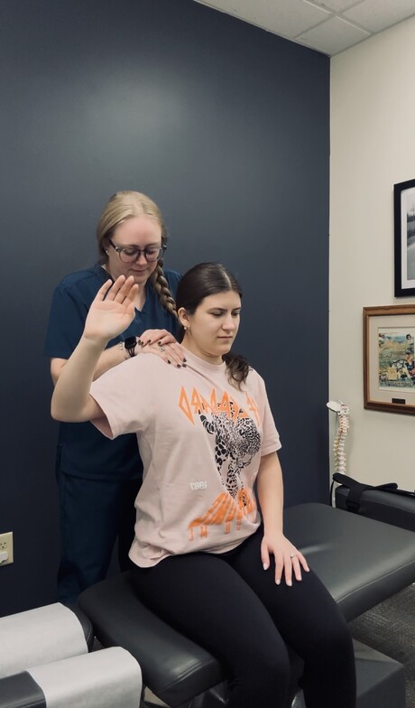 Dr. Kate Denker performing Active Release Technique on a patient's shoulder in Somerville, NJ